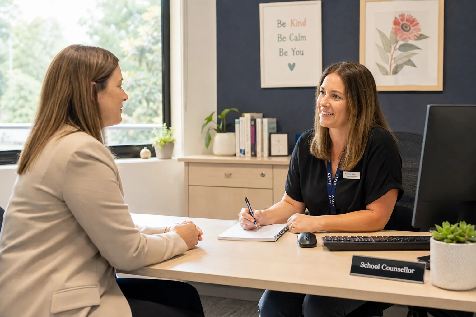 A parent having a productive meeting with a school counsellor in an Australian school office